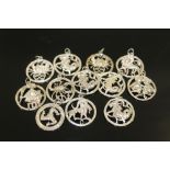 A BAG OF STERLING SILVER SIGNS OF THE ZODIAC PENDANTS