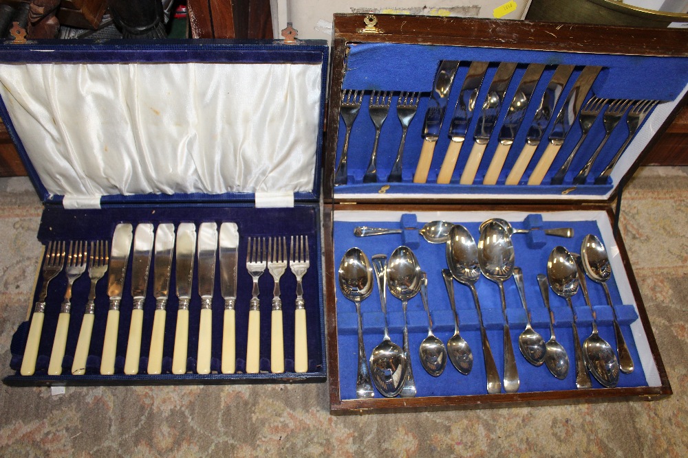 A VINTAGE OAK CASED CANTEEN OF CUTLERY together with another (2)