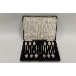A CASED SET OF TWELVE GRAPEFRUIT TYPE SPOONS WITH A PAIR OF SUGAR TONGS BY LIBERTY & Co. GLASGOW