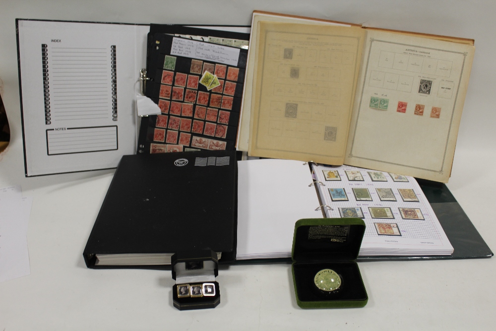 FOUR ALBUMS OF BRITISH AND WORLD STAMPS, TOGETHER WITH A PENNY BLACK CUFFLINK SET AND A PAPERWEIGHT