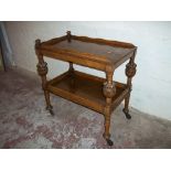 AN ANTIQUE SERVING TROLLEY WITH SLIGHT TRIM DAMAGE