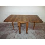 A LARGE DROPLEAF OAK DINING TABLE
