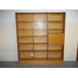 AN OAK FINISHED BOOKCASE WALL UNIT