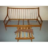 A WOODEN THREE SEATER SOFA WITH ERCOL STYLE FRAME AND FOOTSTOOL