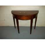 A MAHOGANY HALF MOON FLIP TOP TABLE