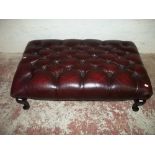 A LARGE CHESTERFIELD STYLE OXBLOOD LEATHER FOOTSTOOL