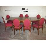 AN ANTIQUE EXTENDING DINING TABLE AND EIGHT SABRE LEG CHAIRS