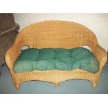 A WICKER TWO SEATER SOFA