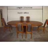 A MODERN SKOVBY EXTENDING DINING TABLE AND SIX CHAIRS