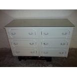 A WHITE SIX DRAWER LOUIS STYLE CHEST WITH GLASS TOP