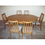 A G-PLAN TEAK EXTENDING TABLE AND SIX CHAIRS