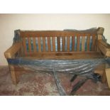 A HEAVY SOLID HARDWOOD GARDEN BENCH