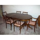 A MAHOGANY EXTENDING DOUBLE PEDESTAL DINING TABLE AND SIX CHAIRS INCLUDING TWO CARVERS