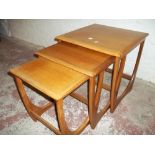 A RETRO TEAK STYLISM NEST OF THREE TABLES