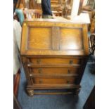 A 1920'S/30'S CARVED OAK BUREAU WITH THREE DRAWERS H-107 CM W-78 CM