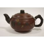 AN ORIENTAL CERAMIC TERRACOTTA STYLE TEAPOT DECORATED WITH FLOWERS WITH CHARACTER MARKING TO BASE