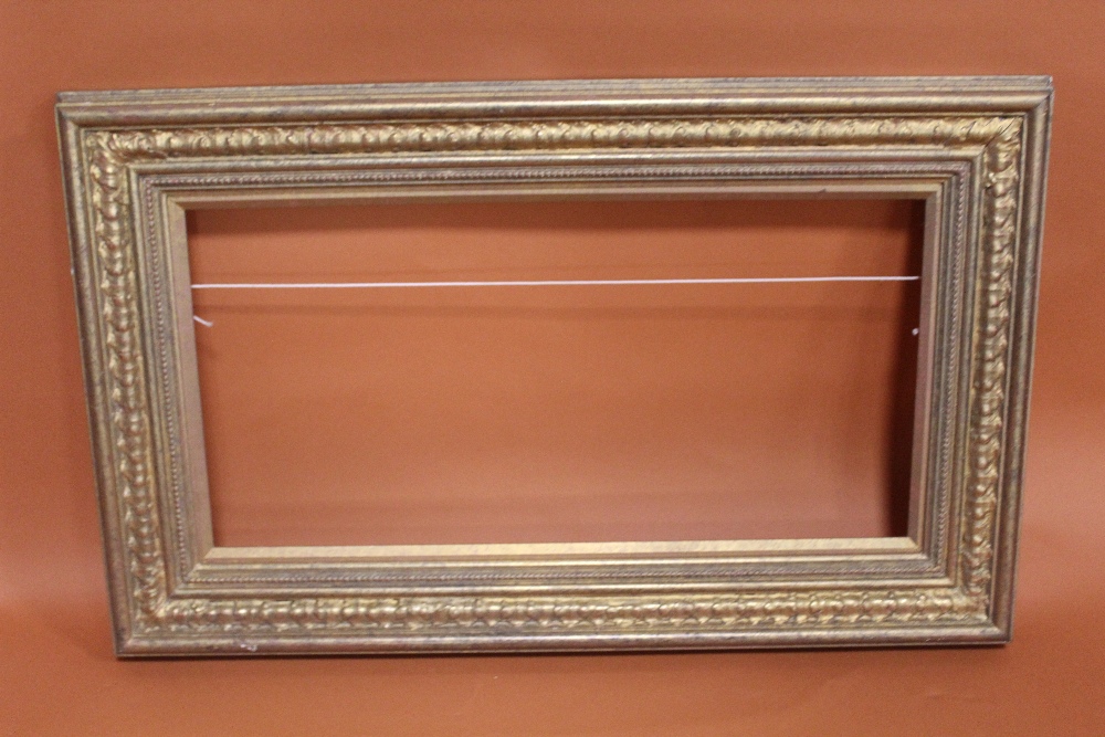 A 20TH CENTURY GILT PICTURE FRAME WITH GOLD SLIP -SLIP REBATE 31CM X 62CM FRAME REBATE - 34CM X 65CM