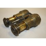 A PAIR OF VINTAGE FLORALLY EMBOSSED BRASS BINOCULARS