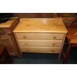 A PINE THREE DRAWER CHEST ON LEGS