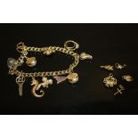 A HALLMARKED 9CT GOLD CHARM BRACELET WITH CHARMS ATTACHED AND A SMALL QUANTITY OF LOOSE CHARMS,