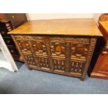 AN ANTIQUE OAK JACOBEAN STYLE DEEP COFFER, the hinged lift-up lid above a carved and moulded