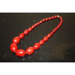 A CHERRY AMBER SINGLE STRAND GRADUATED BEAD NECKLACE, LARGEST BEAD W 2.8 cm, APPROX WEIGHT 46.9 g