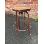 AN INDUSTRIAL METAL AND WOOD CIRCULAR TALL STOOL WITH ADJUSTABLE SEAT