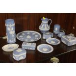 A COLLECTION OF WEDGWOOD JASPERWARE TO INCLUDE A CYLINDRICAL VASE, TABLE LIGHTER, TRINKET BOXES ETC.