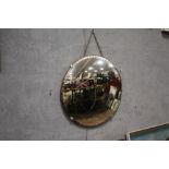 A VINTAGE CIRCULAR CONVEX WALL MIRROR