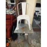 AN INDUSTRIAL STYLE METAL BISTRO TABLE AND A WHITE METAL CHAIR