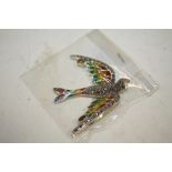 A STERLING SILVER PLIQUE-A-JOUR BROOCH IN THE FORM OF A BIRD IN FLIGHT