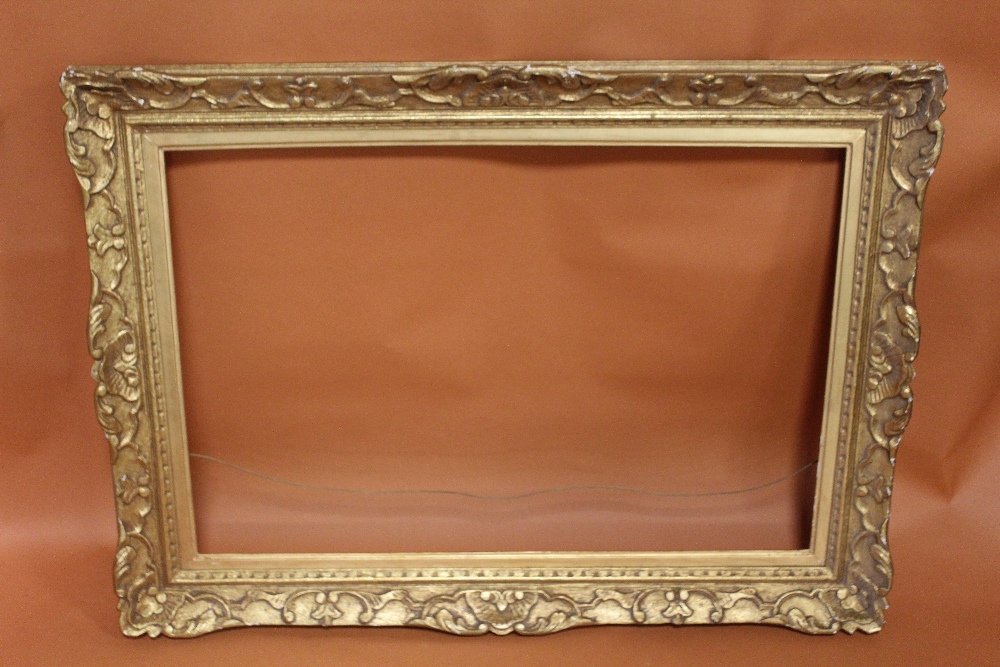 A 19TH CENTURY GILT SWEPT FRAME WITH GOLD SLIP - SLIP REBATE 55CM X 82CM, FRAME REBATE 59CM X 86CM