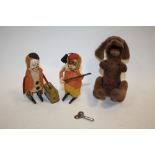 THREE VINTAGE WIND UP TOYS TO INCLUDE A GERMAN CLOWN AND MONKEY AND A WOOFING DOG