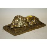 A VINTAGE BRASS DESK WEIGHT IN THE FORM OF A SLEEPING LION