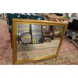 A LARGE GILT FRAMED BEVEL EDGED WALL MIRROR 116 CM X 91 CM