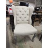 A MODERN UPHOLSTERED WING CHAIR