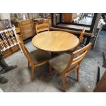 A RETRO NATHAN TEAK EXTENDING DINING TABLE AND FOUR CHAIRS