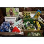 TWO TRAYS OF BOXED GIFTWARE TO INCLUDE JOHN DEERE COLLECTABLES, HIPPIE COSTUME ETC.
