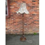 A VINTAGE OAK BARLEY TWIST STANDARD LAMP WITH FLORAL SHADE