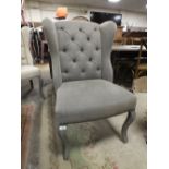 A MODERN UPHOLSTERED WING CHAIR