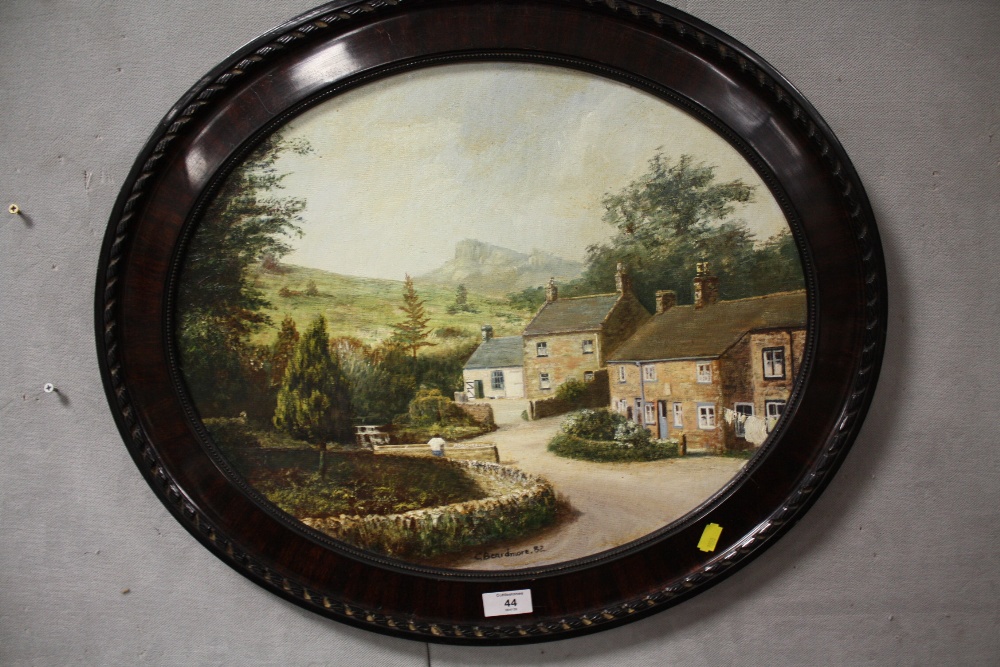 AN OVAL FRAMED OIL ON BOARD DEPICTING A COUNTRY VILLAGE SCENE SIGNED C. BEARDMORE