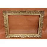 A 19TH CENTURY GILT SWEPT FRAME WITH GOLD SLIP - SLIP REBATE 55CM X 82CM, FRAME REBATE 59CM X 86CM