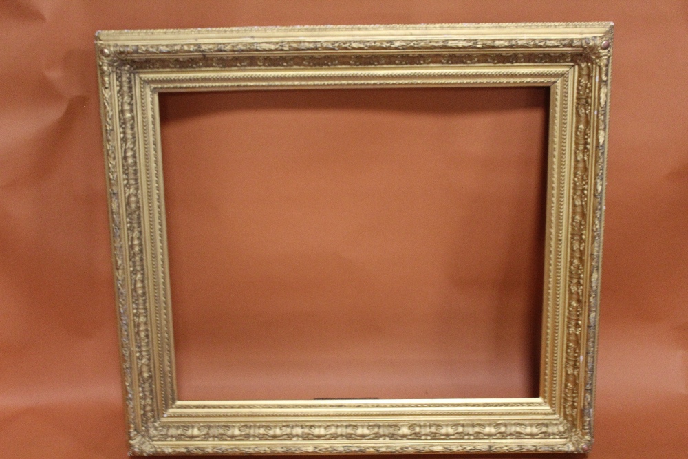 A 19TH CENTURY ACANTHUS LEAF DESIGN GILT PICTURE FRAME - REBATE 58CM X 68CM