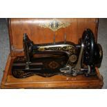 A CASED VINTAGE SINGER SEWING MACHINE