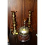 AN UNUSUAL BRASS DESK BELL WITH FACETED GLASS KNOP, TOGETHER WITH A PAIR OF BRASS CANDLESTICKS (3)