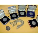 FIVE BOXED HALLMARKED GOLF MEDALS TOGETHER WITH A RELIGIOUS PENDANT AND A WHITE METAL CHAIN