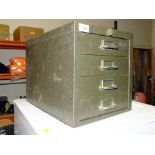 A SMALL FOUR DRAWER METAL FILING CABINET