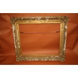 A 19TH CENTURY GILT SWEPT FRAME WITH SLIP, slip rebate 65 x 78 cm, frame rebate 73 x 85 cm