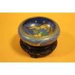 A CHINESE / ORIENTAL CLOISONNE BOWL ON TREEN PLINTH DECORATED WITH A FIVE CLAW DRAGON OVERALL