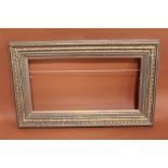 A 20TH CENTURY GILT PICTURE FRAME WITH GOLD SLIP -SLIP REBATE 31CM X 62CM FRAME REBATE - 34CM X 65CM